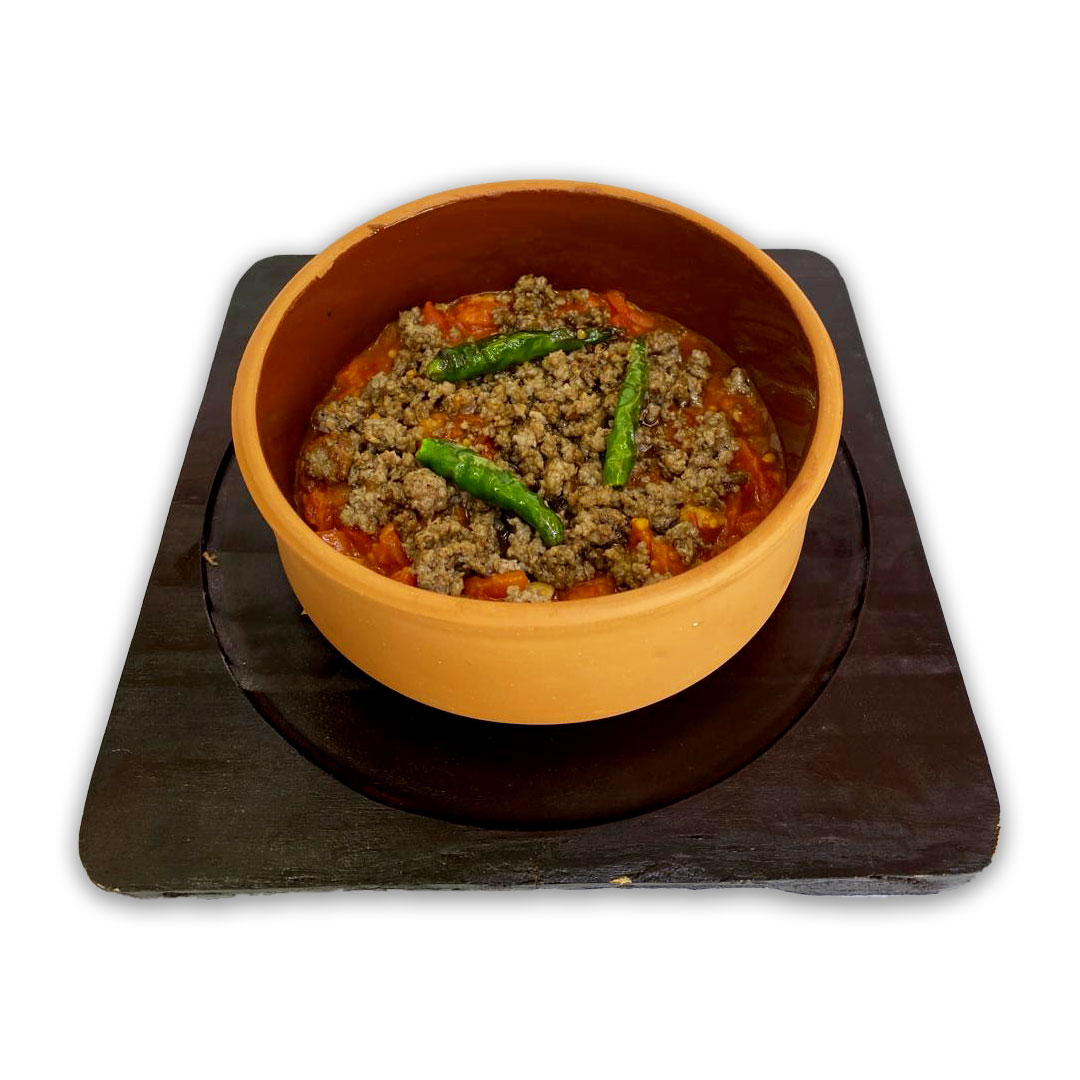 Pottery frying pan with meat tomatoes in the oven